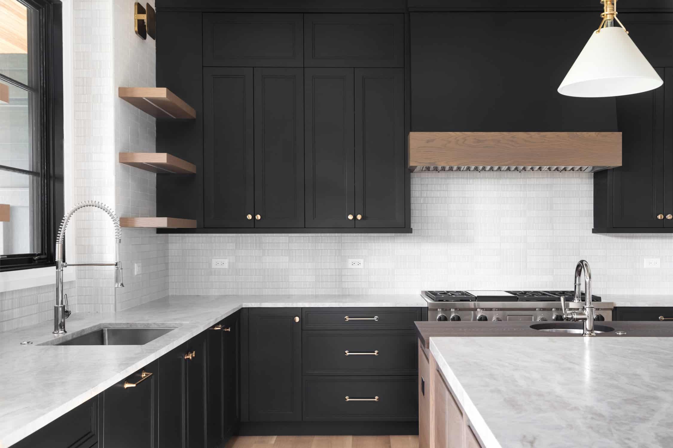 A black kitchen with stainless steel appliances. painting storage cabinet