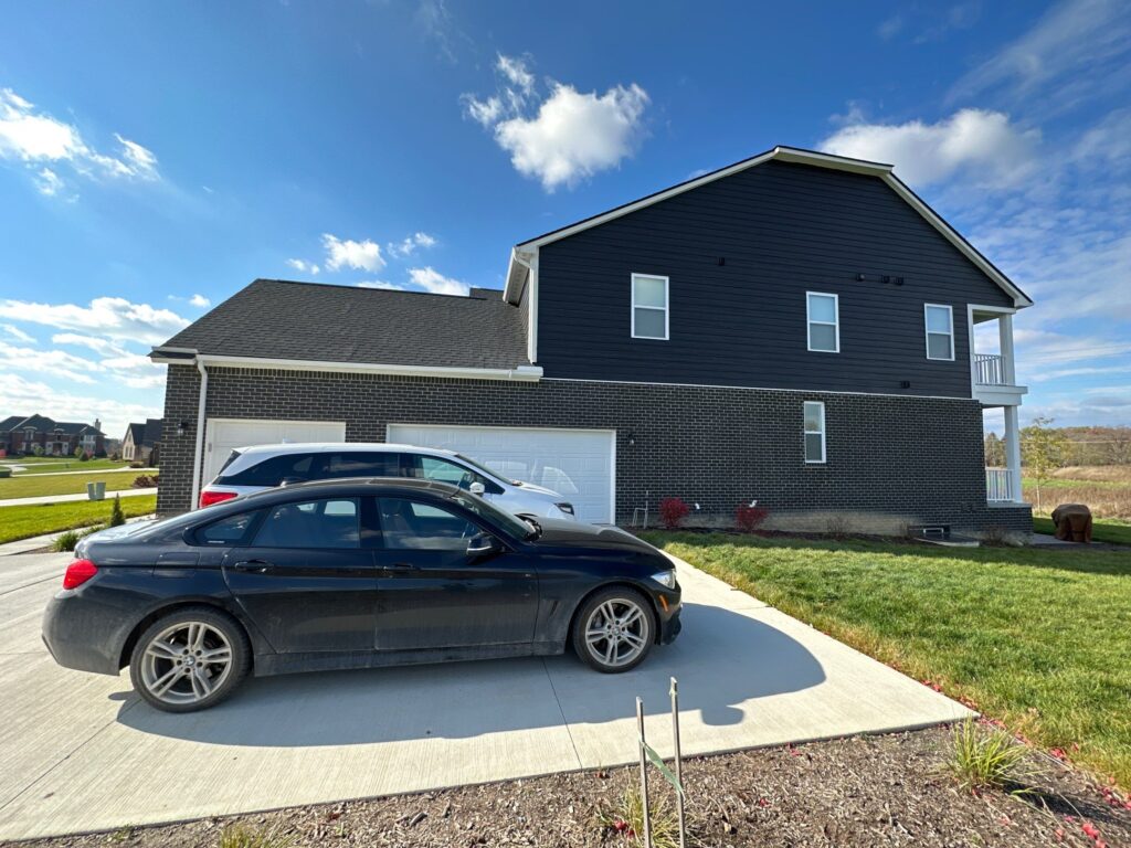 Side view of the house showing the garage and the parking lot.