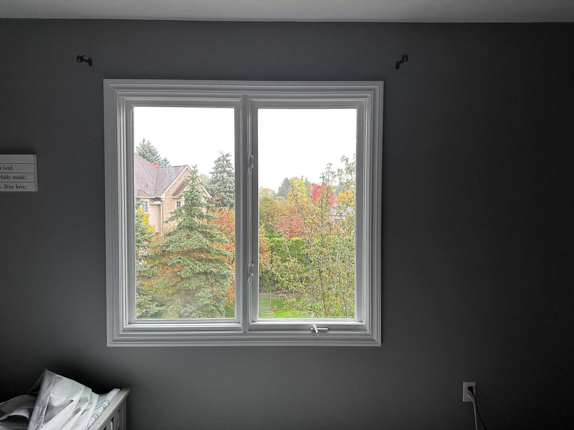 A large white window surrounded with brown walls.