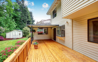 Wooden walkout deck. Well kept garden with bushes and flowers. Northwest, USA